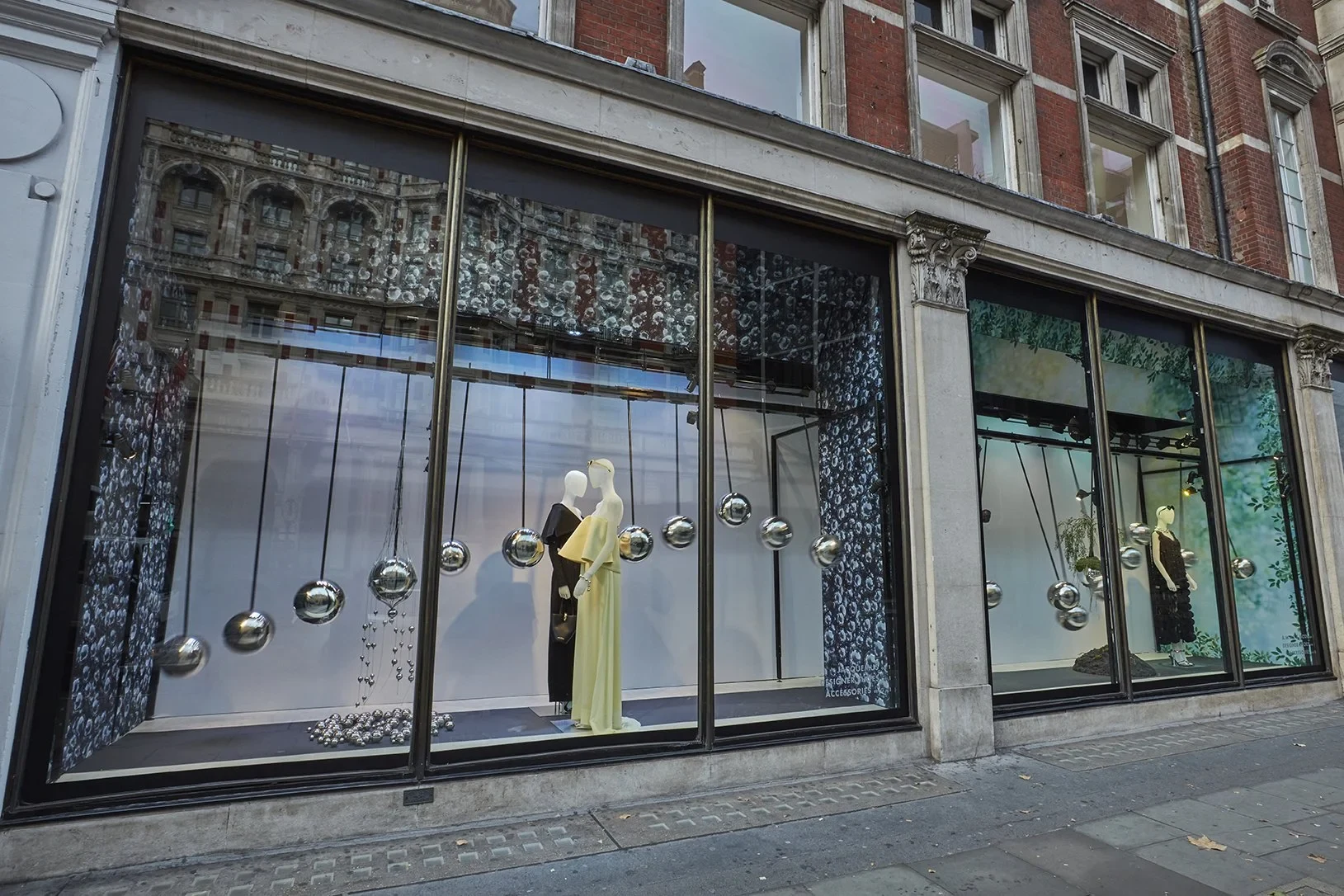 Suspended polished metal spheres in Harvey Nichols retail windows